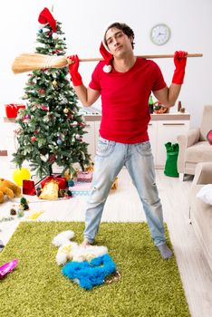 Man cleaning his apartment after christmas party