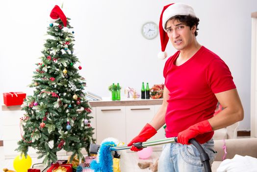 Man cleaning his apartment after christmas party