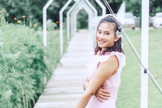 Portrait of asian happy woman smilling with flower garden , Selective focus