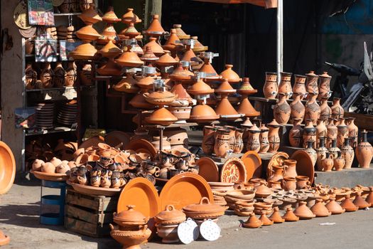 Ceramic stall selling traditional brown orange dishes and tagine in tberber style Casablanca Morocco. High quality photo