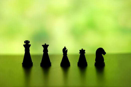 Business strategy conceptual photo - Silhouette of a chess pawn knight in a row