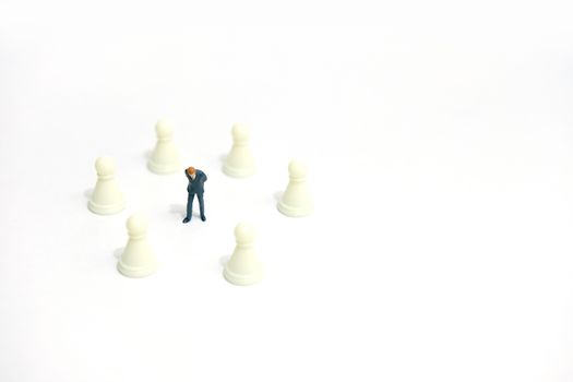 Miniature business strategy concept - businessman standing between chess piece. image photo