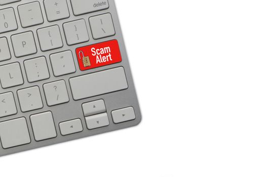 SCAM ALERT text on computer keyboard over white background. Business and Copy space concept