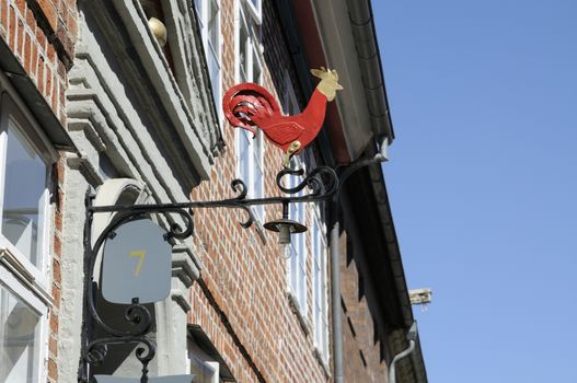 Sign of a red cock seen in Lueneburg, Germany.