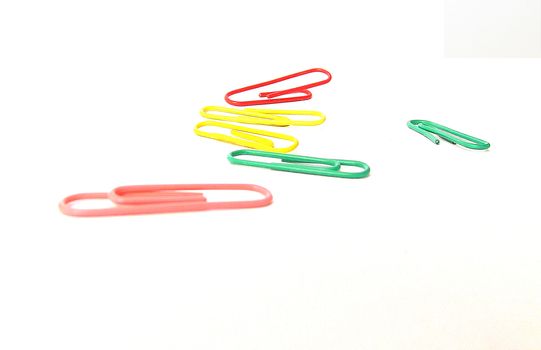 paper clips, items for the office and home plastic products on a white background 
