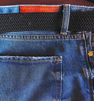 texture of denim, denim material with pockets and a fabric belt close-up