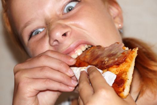 girl greedily eating pizza close-up