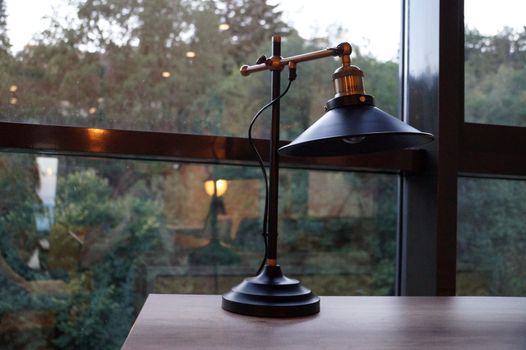 vintage desk lamp on the desk by the window.