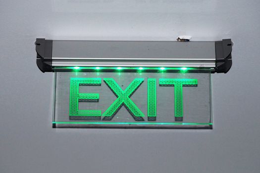 burning sign exit close up on gray background