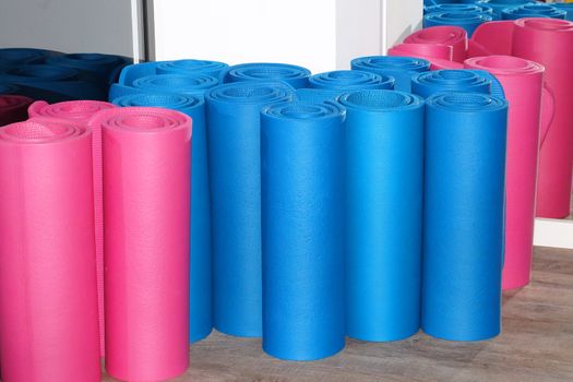 twisted multicolored sports mats in the corner of the gym.