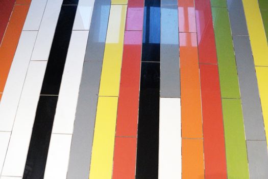 colorful stripes of glossy tiles on the floor