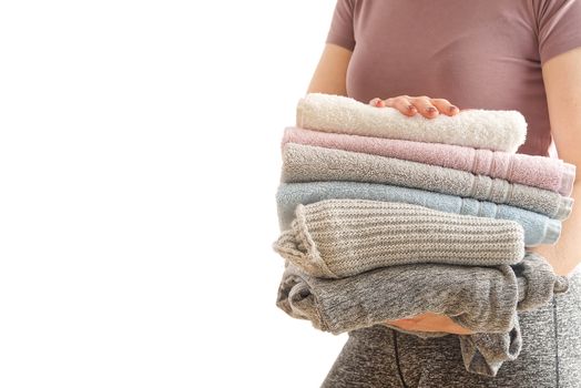 woman holds laundry in hands , soot in pastel colors. bright picture of lovely housewife with towels