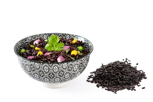 Black rice and vegetables isolated on white background