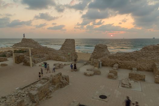 Ashdod, Israel - August 12, 2020: Sunset view of the remains of Ashdod Citadel (Ashdod Yam or Ashdod on the Sea), with visitors. Southern Israel