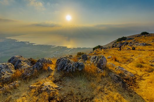 Arbel, Israel - August 14, 2020: Morning view of the Sea of Galilee, from mount Arbel, with visitors. Northern Israel