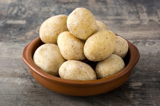 Canarian potatoes (papas arrugadas) on wooden table