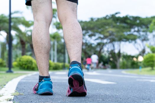 Close up of Athlete shoes while running and walking in park. Sport and exercise concept