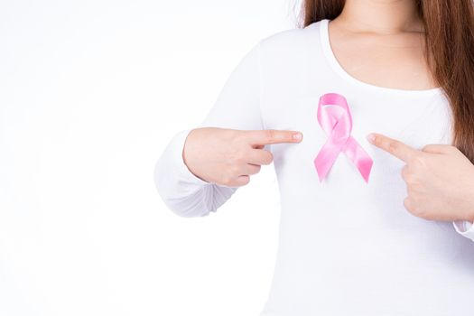 Breast cancer awareness ribbon on woman chest isolated over white background. Medical, healthcare for advertising concept.