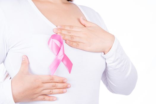 Breast cancer awareness ribbon on woman chest and doing self exam isolated over white background. Medical, healthcare for advertising concept.