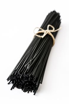 Black spaghetti with prawns isolated on white background