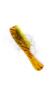 Golden comb with stripes and hair fall as well as dandruff. Phots demostration of hair loss while combing.