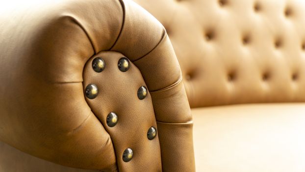 Close up of pins and buttons on a vintage style sofa. Buttoned vintage sofa up close.