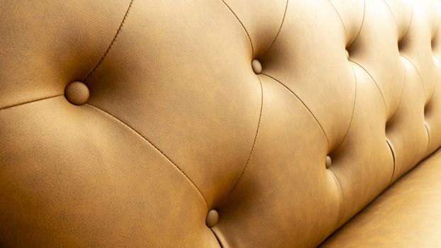 Close up of pins and buttons on a vintage style sofa. Buttoned vintage sofa up close.