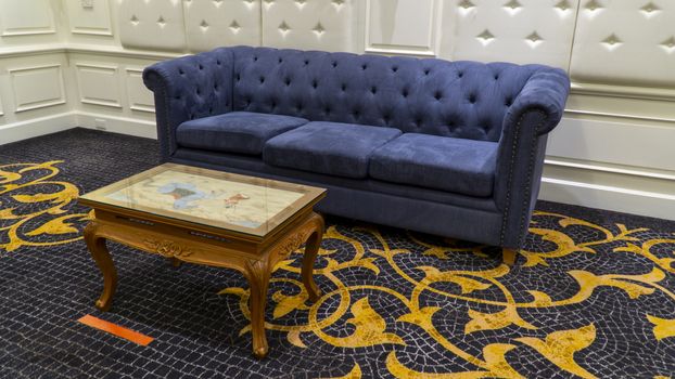 Blue vintage sofa with teak coffee table in a living room.