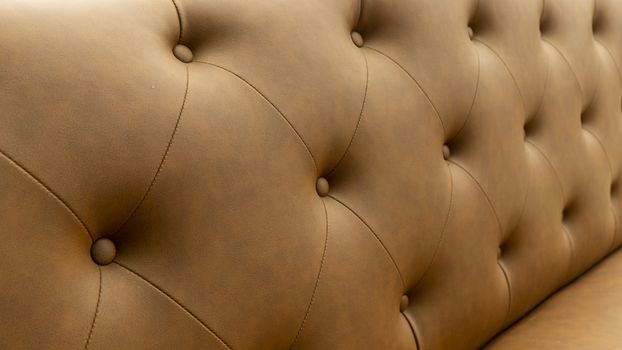 Close up of pins and buttons on a vintage style sofa. Buttoned vintage sofa up close.