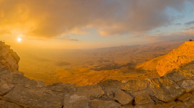 Panoramic sunrise view of cliffs and landscape in Makhtesh (crater) Ramon, the Negev Desert, Southern Israel