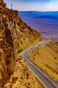 View of cliffs, landscape, and road in Makhtesh (crater) Ramon, the Negev Desert, Southern Israel