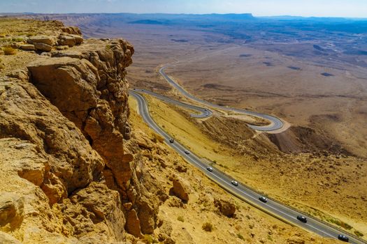 View of cliffs, landscape, and hairpinned road in Makhtesh (crater) Ramon, the Negev Desert, Southern Israel