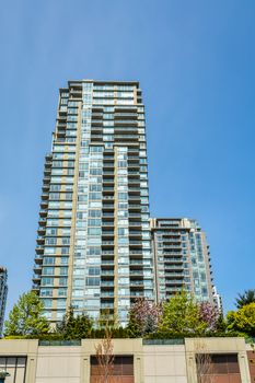 High rise residential building in Vancouver on blue sky background
