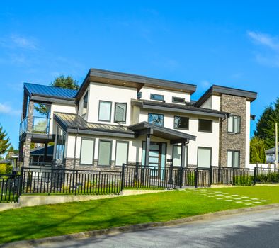 New luxury house for sale. Residential house with a car parked on the road in front