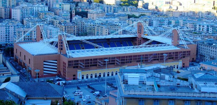 Genoa, Italy – August 5, 2020: Aerial view of shipping and container terminal, stacked containers and loading dock side cranes in the port of Genoa, Magazzini del cotone and Porto Antico, sea