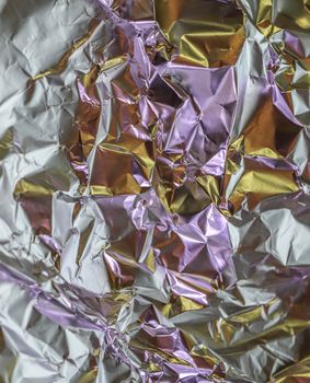 Detailed close up texture of an aluminum foil surface in different colors