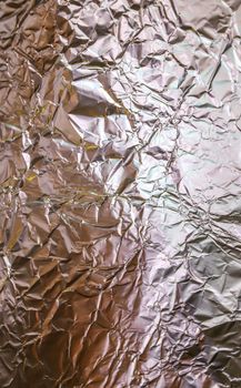 Detailed close up texture of an aluminum foil surface in different colors