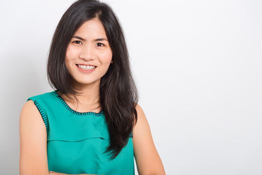 Portrait Asian beautiful young woman standing smile seeing white teeth, She looking at the camera, shoot photo in studio on white background. There was a copy space to put text on the right-hand side.