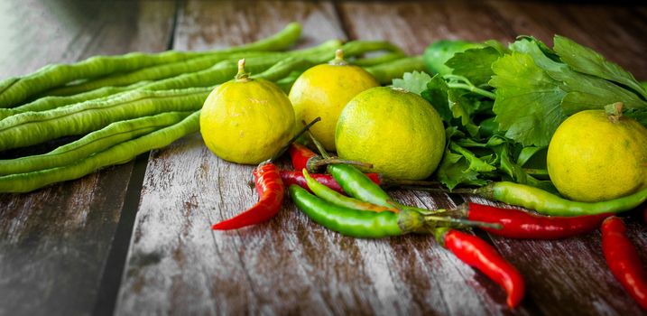 Gathering of vegetables on wood background, green papaya salad