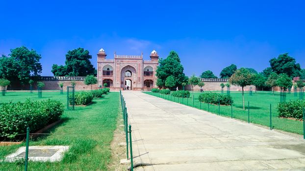 The Taj Mahal seven wonders of the world. A different view of Taj Maha from far distant with lush greeneries in front. Photography from Agra Fort, South Asia Pac India. August 15 2019