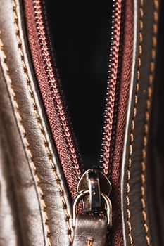zipper of brown leather bag, close-up view