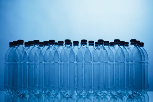 empty plastic bottle silhouettes on blue background