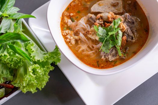 Rice noodle soup with Cooked Liver in  bowl on table, selective focus