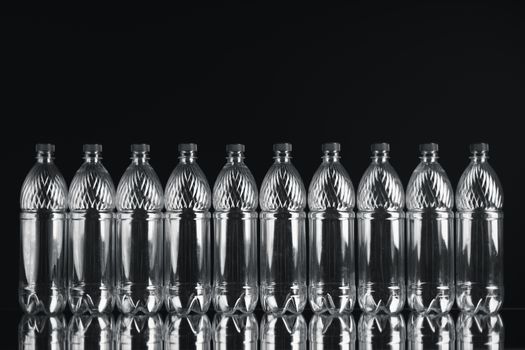 empty plastic bottles on black background