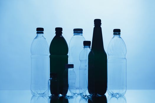 empty plastic bottle silhouettes on blue background