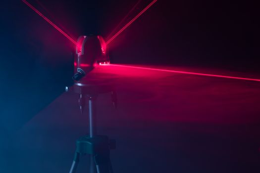 laser level tool red light beams, abstract background