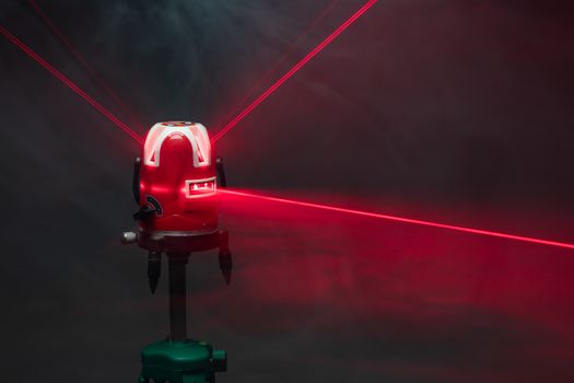 laser level tool red light beams in smoke