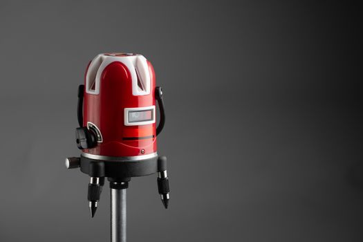 red laser level tool on grey background