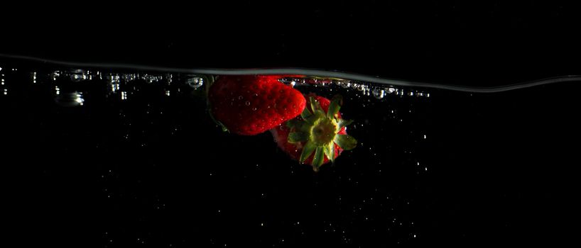 Colorful freshness fruit falling in to water splash and black background