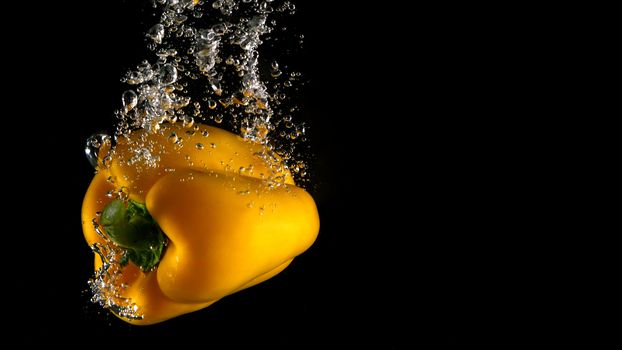 Colorful fresh vegetable cleaning by drop in to water splash and black background.